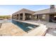 Long rectangular pool with tan tile deck and covered patio at 10400 E Breathless Ave, Gold Canyon, AZ 85118