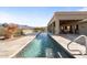 Long, rectangular pool with mountain views and a large patio area at 10400 E Breathless Ave, Gold Canyon, AZ 85118