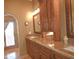 Double vanity bathroom with granite countertops and wood cabinets at 10400 E Breathless Ave, Gold Canyon, AZ 85118