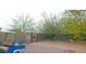 Landscaped front yard with gravel and desert plants, featuring an ornate metal gate and golf cart at 10400 E Breathless Ave, Gold Canyon, AZ 85118