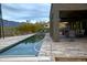 Long, narrow pool with a patio and mountain views at 10400 E Breathless Ave, Gold Canyon, AZ 85118