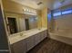 Double vanity bathroom with tub and separate toilet at 11410 W Cocopah St, Avondale, AZ 85323