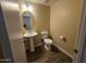 Clean bathroom with pedestal sink, toilet and updated flooring at 11410 W Cocopah St, Avondale, AZ 85323