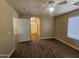 Bedroom with wood-look floors, ceiling fan and en-suite bathroom at 11410 W Cocopah St, Avondale, AZ 85323