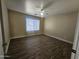 Bright bedroom with wood-look floors and ceiling fan at 11410 W Cocopah St, Avondale, AZ 85323