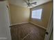 Bright bedroom with ceiling fan and wood-look flooring at 11410 W Cocopah St, Avondale, AZ 85323