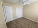 Bedroom with mirrored closet doors and wood-look flooring at 11410 W Cocopah St, Avondale, AZ 85323