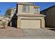 Two-story house with tan exterior, two-car garage, and landscaping at 11410 W Cocopah St, Avondale, AZ 85323