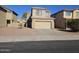 Two-story house with tan exterior, two-car garage, and landscaping at 11410 W Cocopah St, Avondale, AZ 85323