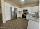 Modern kitchen with stainless steel appliances and white cabinets at 11410 W Cocopah St, Avondale, AZ 85323