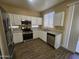 Modern kitchen with white cabinets, stainless steel appliances, and granite countertops at 11410 W Cocopah St, Avondale, AZ 85323