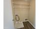 Laundry room with wire shelving and drain at 11410 W Cocopah St, Avondale, AZ 85323