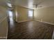 Open loft area with wood-look floors and window with blinds at 11410 W Cocopah St, Avondale, AZ 85323