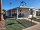 Single-wide manufactured home with covered porch and landscaped yard at 120 N Val Vista Dr # 202, Mesa, AZ 85213