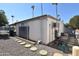 Mobile home exterior with solar panels and a paved pathway at 120 N Val Vista Dr # 202, Mesa, AZ 85213