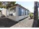 Side view of mobile home with window and landscaping at 120 N Val Vista Dr # 202, Mesa, AZ 85213