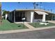 Mobile home features a covered carport and small yard at 120 N Val Vista Dr # 202, Mesa, AZ 85213