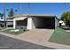 Mobile home with carport and landscaped yard at 120 N Val Vista Dr # 202, Mesa, AZ 85213