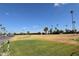 Scenic view of a lush green golf course with palm trees at 120 N Val Vista Dr # 202, Mesa, AZ 85213