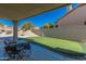 Covered patio with seating area and putting green at 12312 E Poinsettia Dr, Scottsdale, AZ 85259