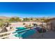 Aerial view of a refreshing pool with a waterfall feature, and mountain views at 12312 E Poinsettia Dr, Scottsdale, AZ 85259