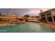 Stunning pool and backyard landscape with a waterfall and rainbow at 12312 E Poinsettia Dr, Scottsdale, AZ 85259