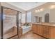 Elegant bathroom with double vanity, soaking tub, and shower at 13428 S 186Th Ave, Goodyear, AZ 85338