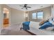 Bright bedroom with ensuite bathroom access and a ceiling fan at 13428 S 186Th Ave, Goodyear, AZ 85338