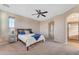 Spacious bedroom with ensuite bathroom and ceiling fan at 13428 S 186Th Ave, Goodyear, AZ 85338