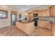 Kitchen with an island, granite countertops, and light wood cabinets at 13428 S 186Th Ave, Goodyear, AZ 85338