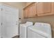 Laundry room with washer, dryer, and cabinets at 13428 S 186Th Ave, Goodyear, AZ 85338