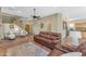 Bright living room featuring a comfortable leather sofa and a view of the kitchen at 13428 S 186Th Ave, Goodyear, AZ 85338