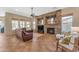 Open living room showcasing a stone fireplace and ample natural light at 13428 S 186Th Ave, Goodyear, AZ 85338