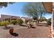 Landscaped backyard with desert plants and a rock water feature at 14137 W Via Manana --, Sun City West, AZ 85375