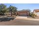 Tan house with a two-car garage and nicely landscaped yard at 14137 W Via Manana --, Sun City West, AZ 85375