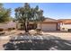 Tan house with a tile roof, double garage, and desert landscaping at 14137 W Via Manana --, Sun City West, AZ 85375