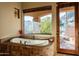 Bathroom with soaking tub and private access to backyard at 14597 E Corrine Dr, Scottsdale, AZ 85259