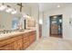 Double vanity bathroom with wood cabinets and view to bedroom at 14597 E Corrine Dr, Scottsdale, AZ 85259