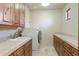 Laundry room with wood cabinets and countertop space at 14597 E Corrine Dr, Scottsdale, AZ 85259