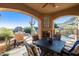 Covered patio with fireplace, seating area, and mountain views at 14597 E Corrine Dr, Scottsdale, AZ 85259