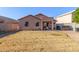 Large backyard, featuring a home with covered patio at 14749 N 153Rd Dr, Surprise, AZ 85379