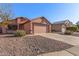 One-story house with a two-car garage and desert landscaping at 14749 N 153Rd Dr, Surprise, AZ 85379