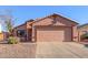 One-story house with a two-car garage and desert landscaping at 14749 N 153Rd Dr, Surprise, AZ 85379