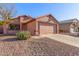 One-story house with a two-car garage and desert landscaping at 14749 N 153Rd Dr, Surprise, AZ 85379