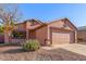 Single story home with two car garage and desert landscaping at 14749 N 153Rd Dr, Surprise, AZ 85379