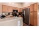 Kitchen features stainless steel appliances and wood cabinets at 14749 N 153Rd Dr, Surprise, AZ 85379