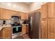 Modern kitchen with stainless steel appliances and wood cabinets at 14749 N 153Rd Dr, Surprise, AZ 85379