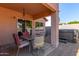 Relaxing covered patio with seating for four at 14749 N 153Rd Dr, Surprise, AZ 85379