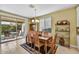 Bright dining room with a table for six and access to the backyard at 15813 N 109Th Ln, Sun City, AZ 85351