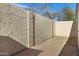 Enclosed backyard featuring painted concrete walls, brick-lined floor and a small faucet at 17242 N 16Th Dr # 9, Phoenix, AZ 85023